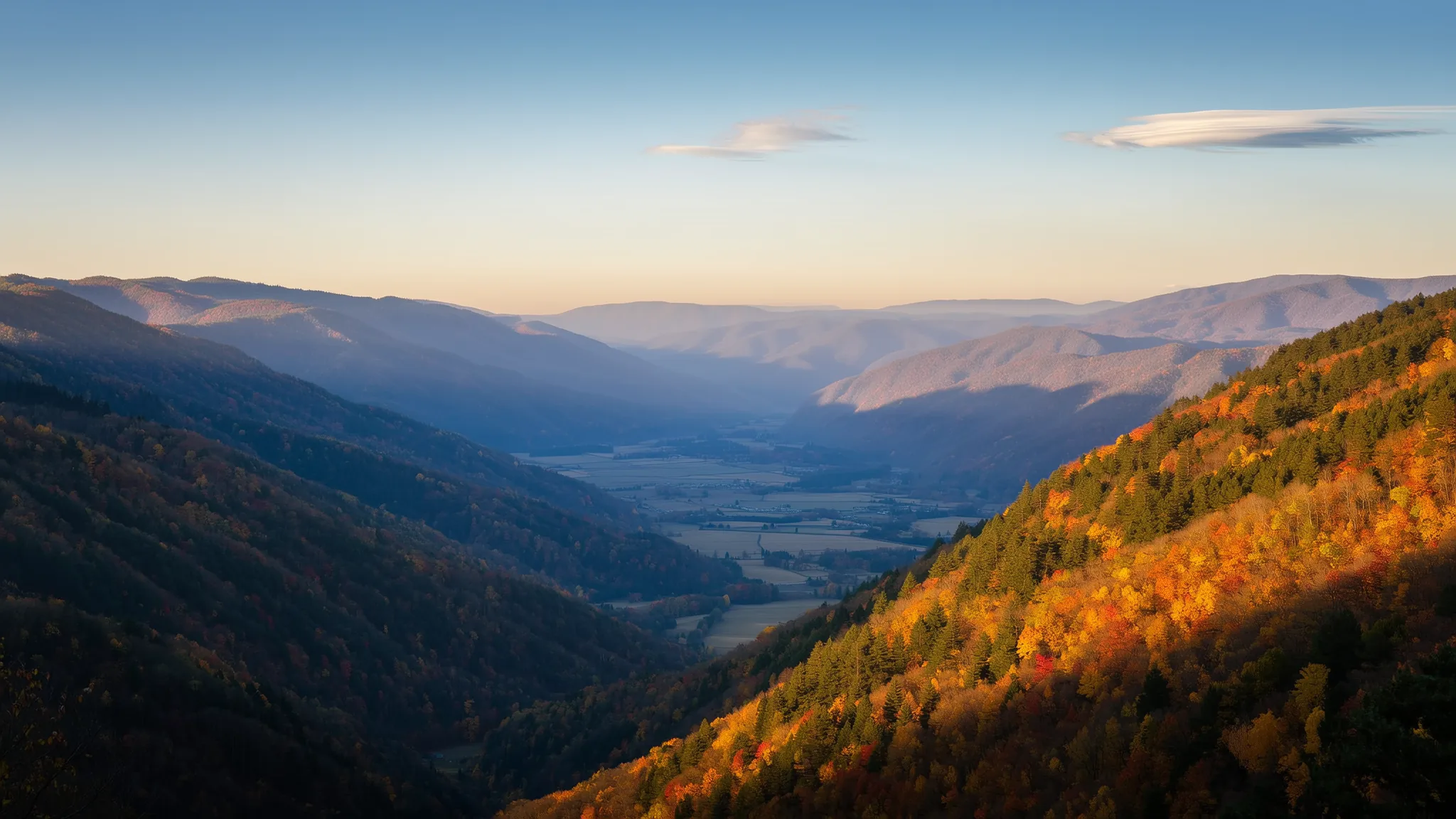 Layered Blue Ridge mountain ridges in autumn at first light, a farmed valley below