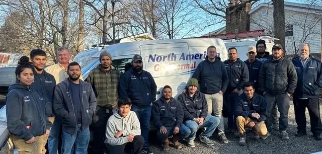 The North American GeoThermal crew standing together outside in front of a company van